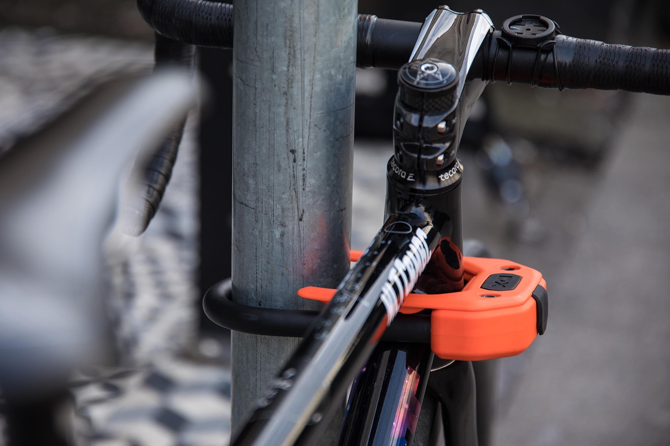 road bike locked to metal post with a d lock