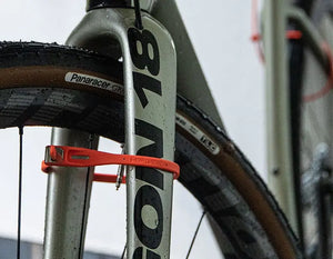 z lok passed through the front wheel and fork of a wet road bicycle