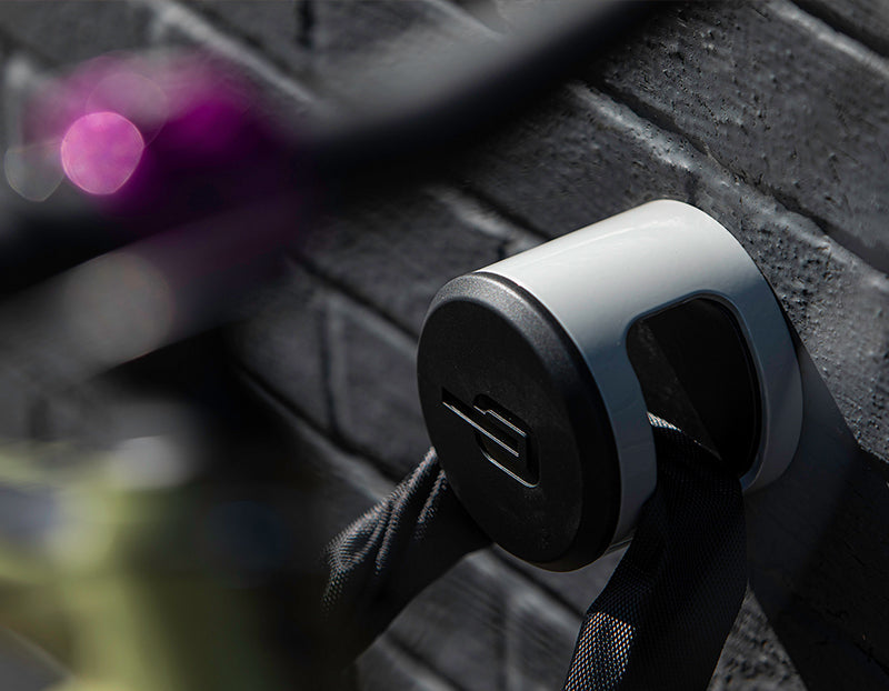 Mountain Bike locked to wall achor with a chain bike lock