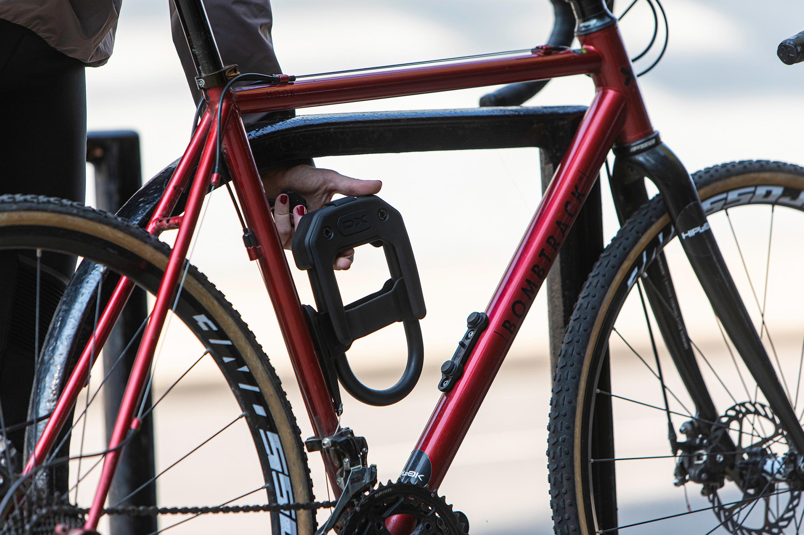 Women removing DX bicycle d lock from seat tube mounted DX frame mount